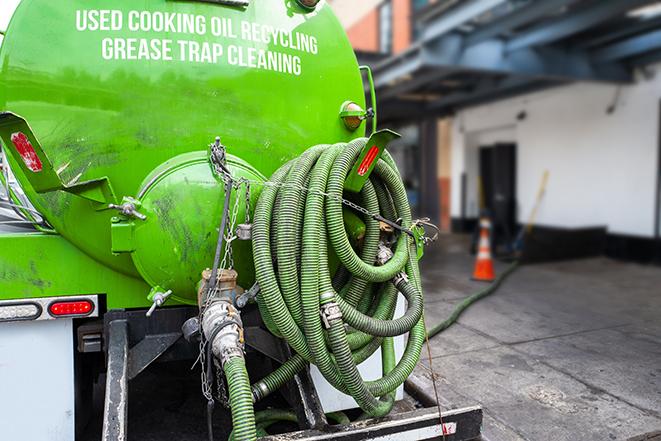 a grease trap being pumped by a sanitation technician in Marysville